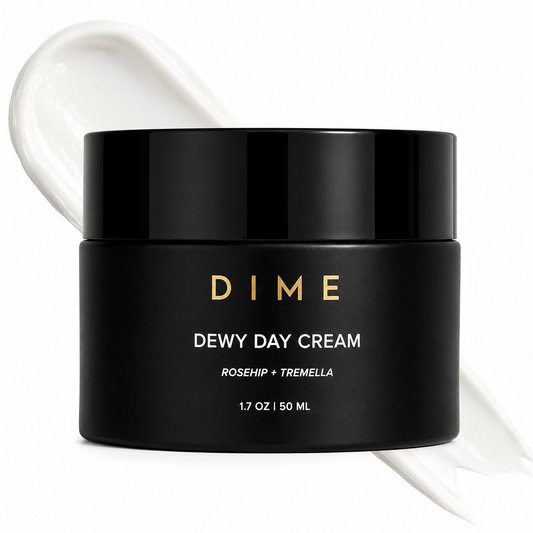 Black jar of DIME Dewy Day Cream with a white cream smear on a white background