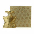 Gold perfume bottle and packaging with a pattern on a white background